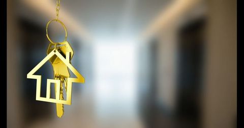 Golden House Keys Hanging in Modern Setting Symbolize Home Ownership
