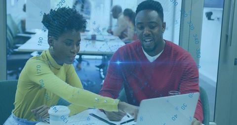 Dynamic Collaboration: Coworkers Analyzing Data in Modern Office