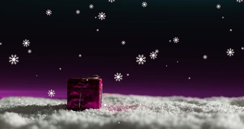 Festive gift in snow with twinkling pink night sky and falling snowflakes