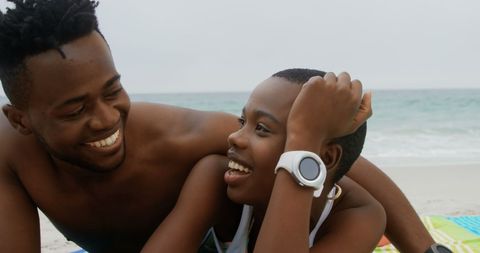 Happy Young African American Couple Relaxing on Beach