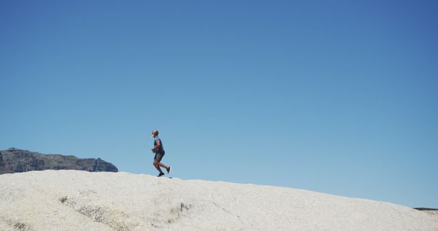 Man Running in Desert Landscape with Clear Blue Sky - Download Free Stock Images Pikwizard.com
