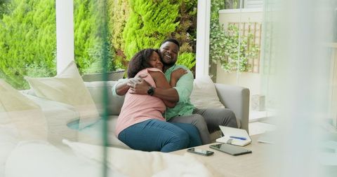 African American Couple Relaxing on Patio with Tablet
