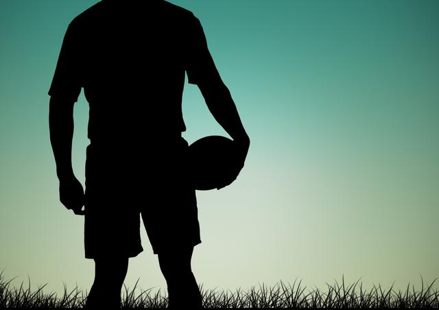 Silhouette of man holding rugby ball against blue sky