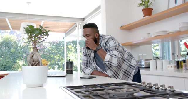 Man Drinking Coffee in Modern Kitchen, Working from Home - Download Free Stock Images Pikwizard.com