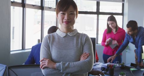 Confident Asian Businesswoman Leading Diverse Team in Modern Office - Download Free Stock Images Pikwizard.com