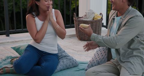 Romantic Proposal on Outdoor Balcony with Basket in Background