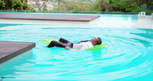 Businessman Relaxing in Pool with Green Inflatable Mat - Download Free Stock Images Pikwizard.com