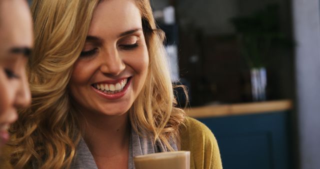 Smiling woman enjoying coffee with friend in cafe - Download Free Stock Images Pikwizard.com