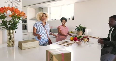 Gift Exchange Among Friends in Modern Kitchen Gathering