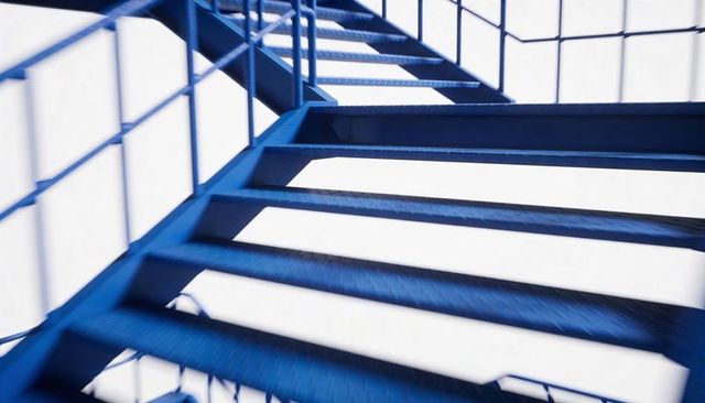Blue Exterior Metal Staircase Casting Geometric Shadows with Diamond-Plate Treads