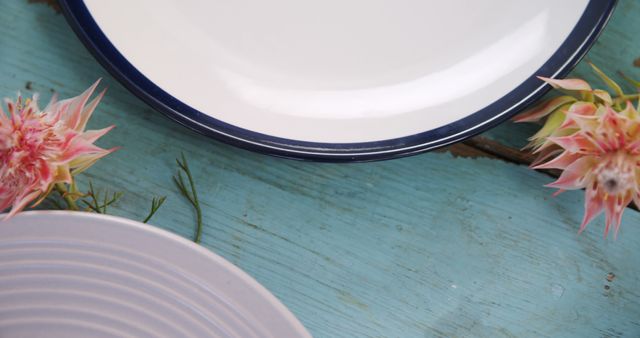 White and Blue Plates on Rustic Wooden Surface with Pink Flowers - Download Free Stock Images Pikwizard.com