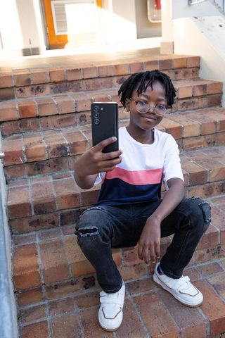 Teen Boy Taking Selfie on Urban Brick Steps