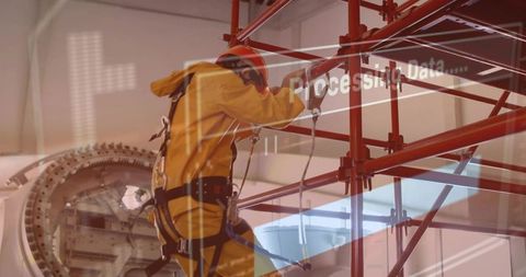 Technician climbing scaffold in yellow suit performing turbine maintenance with data overlay