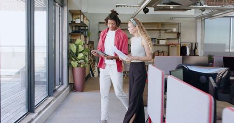 Joyful Team Collaboration with Tablet in Modern Office Setting