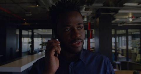 Young Professional Speaking on Smartphone in Modern Office