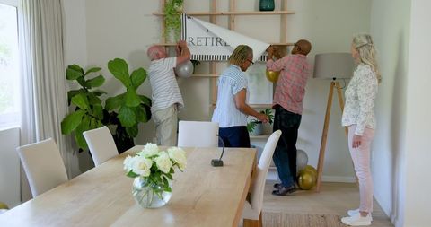 Senior Friends Decorating for Celebration at Home