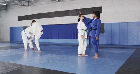 Martial Arts Instructor Training Students in Modern Dojo