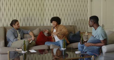 Friends Chatting Over Drinks in Cozy Living Room Setting