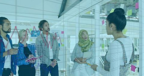 Diverse Team Analyzing Data with Interactive Glass Board