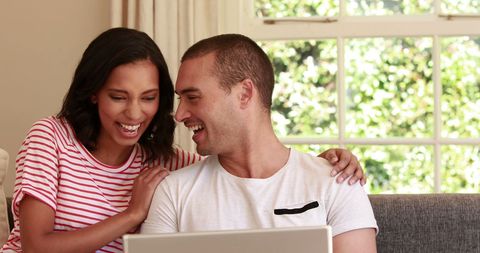 Happy Biracial Couple Enjoying Time Together on Laptop - Download Free Stock Images Pikwizard.com