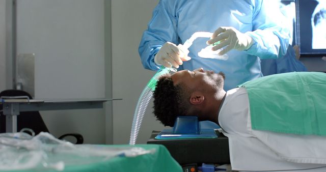 Surgeon during surgery on african american male patient with oxygen mask. Medicine, healthcare, surgery and hospital, unaltered.