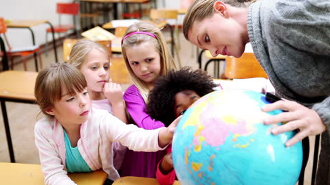 Curious Students Exploring World Globe in Classroom