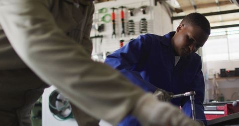 Female Mechanics Working in Auto Repair Shop