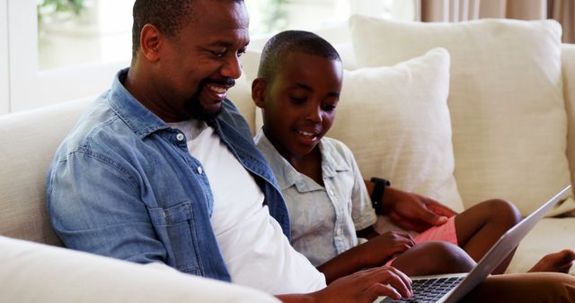 Father and Son Using Laptop on Couch Bonding Time - Download Free Stock Images Pikwizard.com