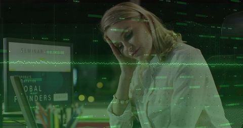 Woman analyzing data on laptop during late night in office