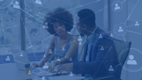 Business Partners Discussing Digital Networking Strategy in Office