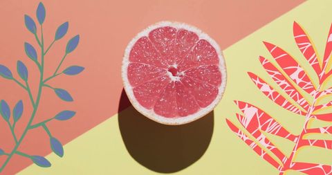 Halved grapefruit with vibrant tropical elements