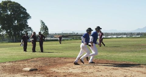 Athletic Baseball Players Racing on Field in Competitive Game