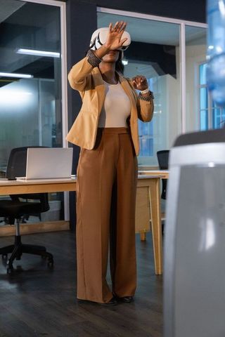 African american businesswoman exploring virtual reality in modern office workspace