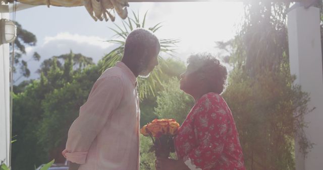 Elderly Couple Sharing Tender Moment Outdoors with Flowers - Download Free Stock Images Pikwizard.com