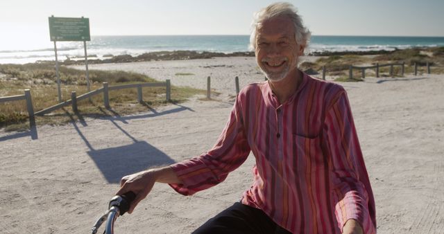 Senior Man Enjoying Sunny Beach Ride on a Bicycle - Download Free Stock Images Pikwizard.com