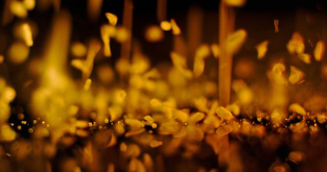 Golden sparks fly in a dark, blurred background. Captures the essence of energy and transformation often associated with industrial work or creative processes.