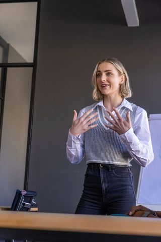 Business Professional Presenting in Modern Meeting Room