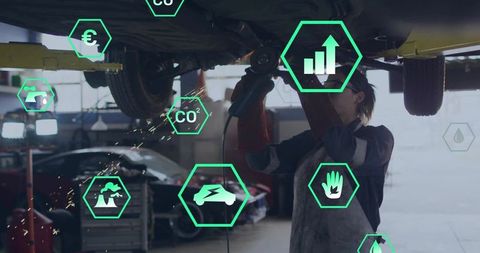 Female mechanic grinding under car on lift with AR hex icons showing electric, CO2, safety