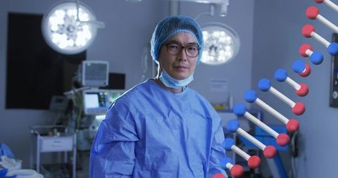 Chinese surgeon standing in operating room wearing gown and cap with dna graphic overlay
