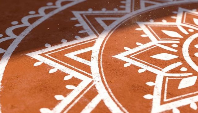 Handmade white mandala on terracotta floor with diagonal sunlight and dust particles