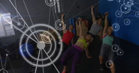 Group holding kettlebells during core strength workout with futuristic fitness overlay