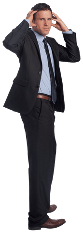 Stressed businessman with hands on head in suit