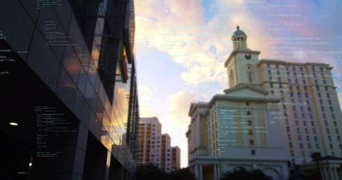 Framing neoclassical tower and dome reflecting glass facade with sunset code overlay