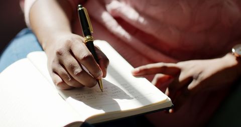 Close-up of African American Woman Writing Notes in Sunlit Room - Download Free Stock Images Pikwizard.com