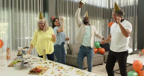 Cheerful Office Celebration with Diverse Team Dancing at Party