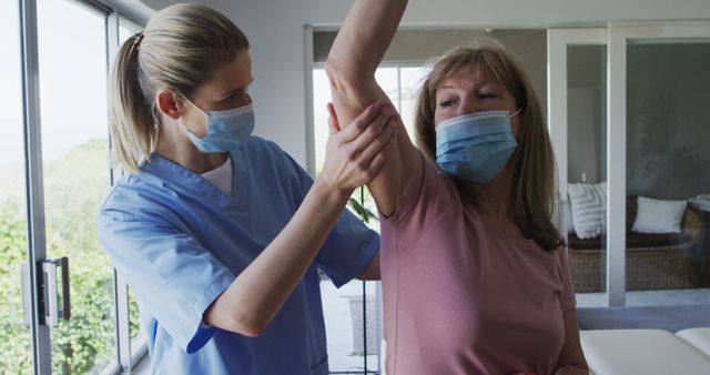 Healthcare Professional Assisting Senior Woman in Physical Therapy Exercise - Download Free Stock Images Pikwizard.com