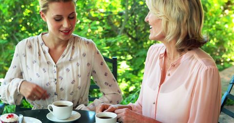 Two Women Enjoying Coffee Outdoors in Warm Conversation - Download Free Stock Images Pikwizard.com