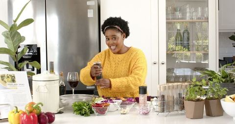 Enthusiastic Chef Preparing Meal in Modern Kitchen