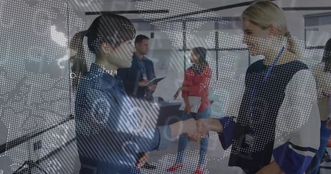 Diverse businesswomen handshake in modern office environment