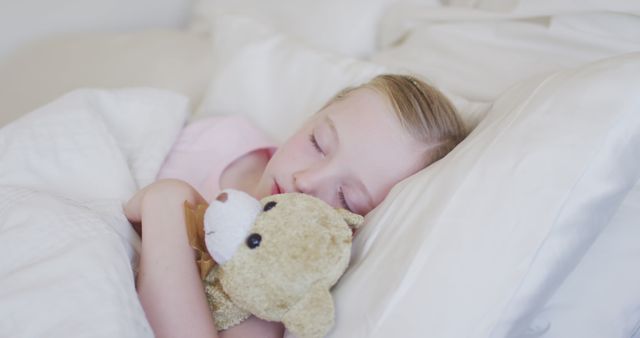 Young child sleeping comfortably with a teddy bear, conveying a sense of peace and innocence. Great for themes related to childhood, bedtime routines, sleep, comfort, and family. Ideal for use in advertising, parenting blogs, sleep products, and children's bedtime stories.